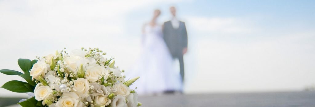 Inn On The Ocean Weddings Bride and Groom on Beach with bouqet